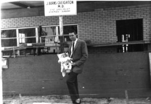 Dr.-Creighton-holding-Darryl-at-first-office-1962